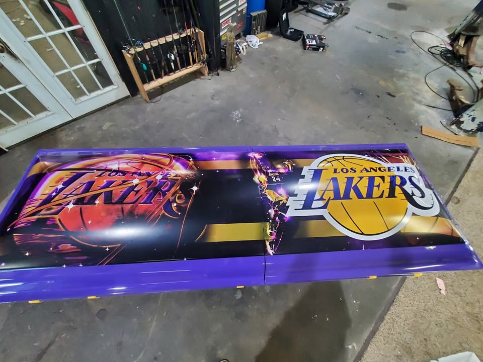 Purple and gold Los Angeles Lakers artwork covering the lid of a casket in the design shop