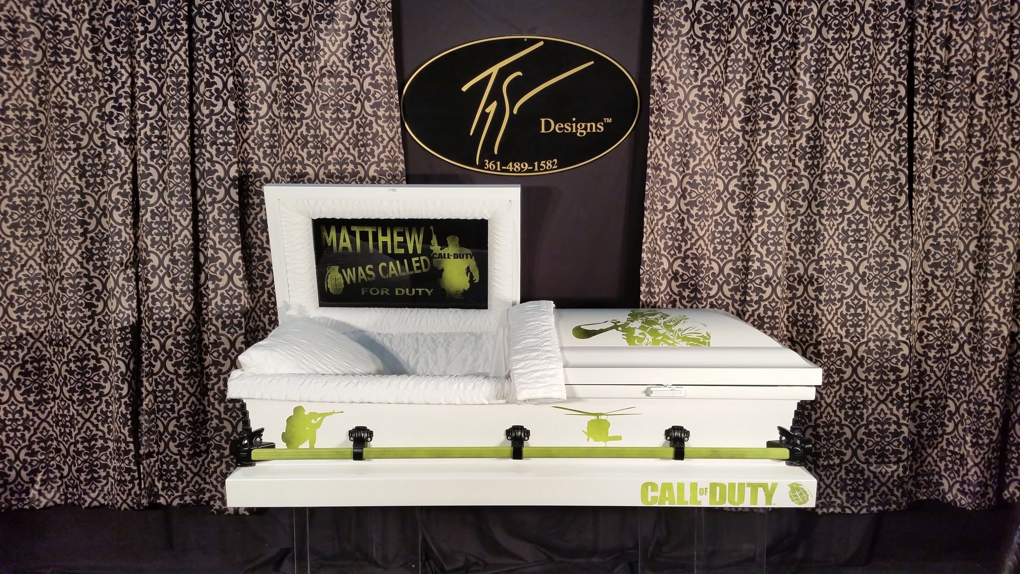 White casket with green Call of Duty soldier graphics reading Matthew Was Called For Duty