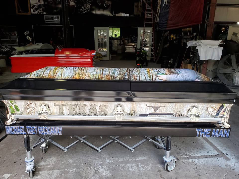 Chrome trimmed casket lettered TEXAS with a longhorn, plus Michael Trey Reckaway and The Man in blue