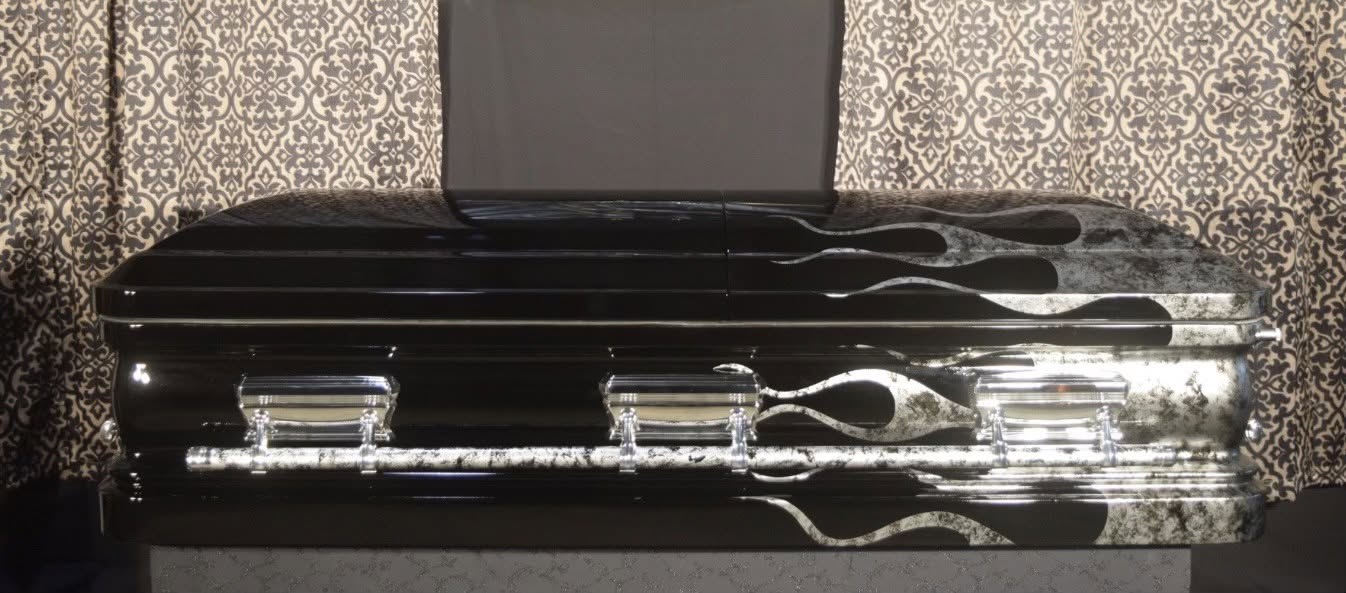 Black casket licked with chrome silver flames down the side and polished bar handles at the front