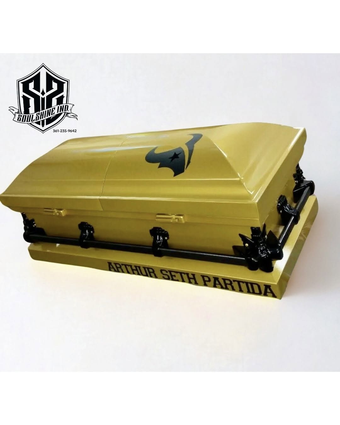 Gold casket with a Houston Texans bull logo, black hardware and Arthur Seth Partida on the base