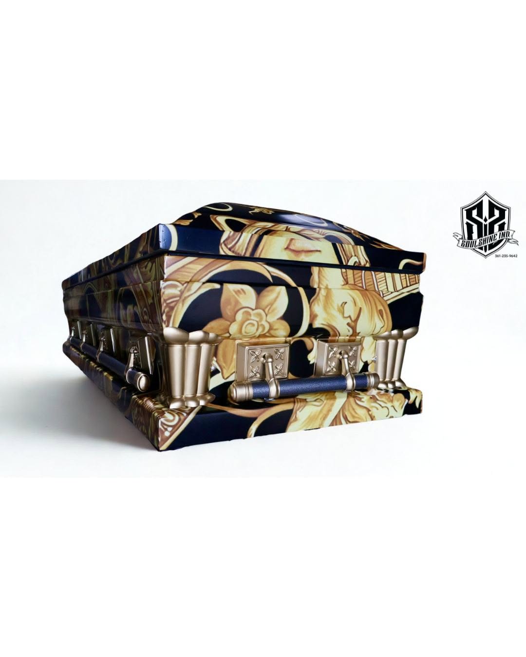 Navy and gold baroque scrollwork print wrapping a casket with brushed gold bar handles