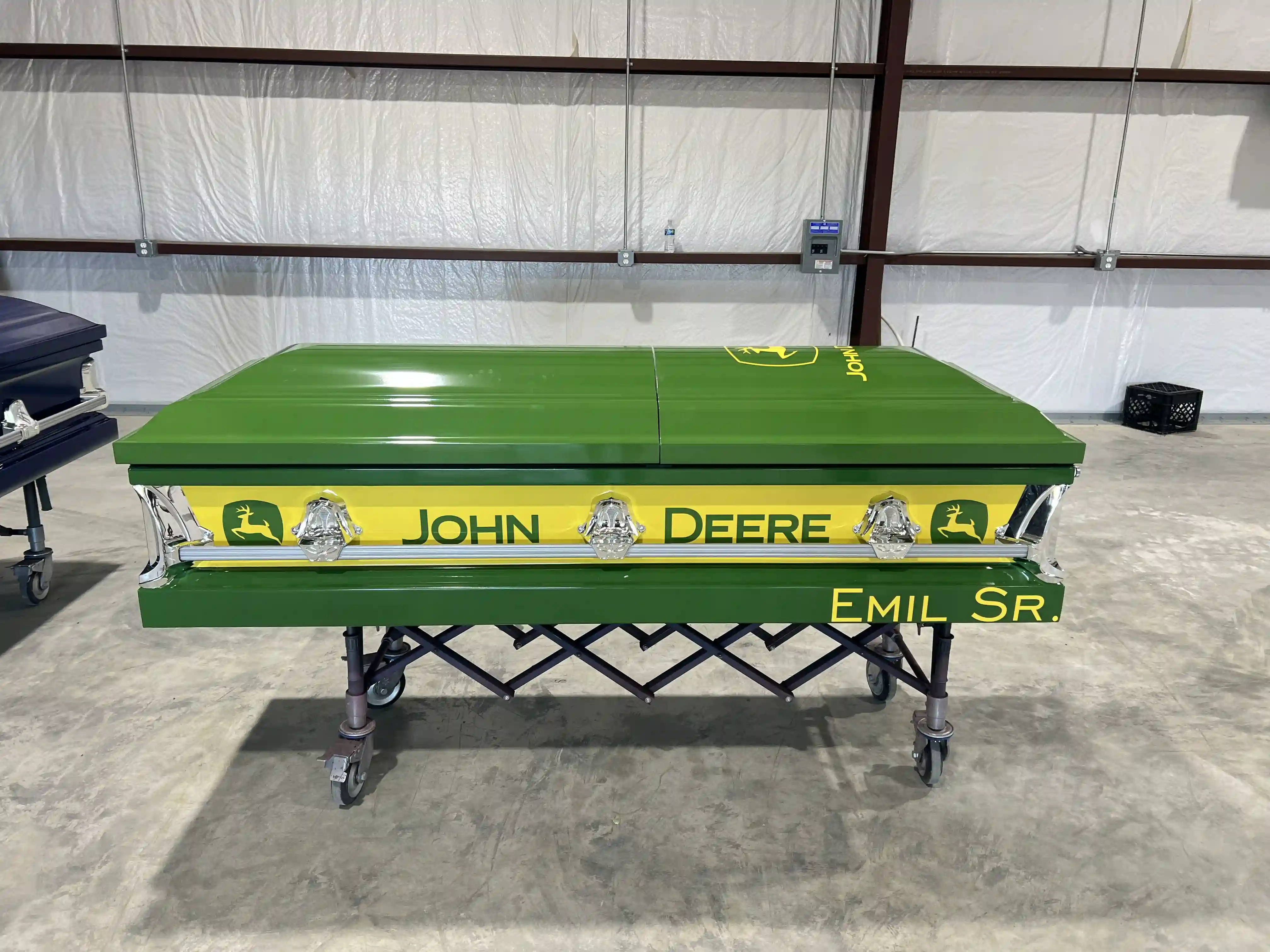 Green and yellow John Deere themed casket on a church truck inside the SoulShine warehouse