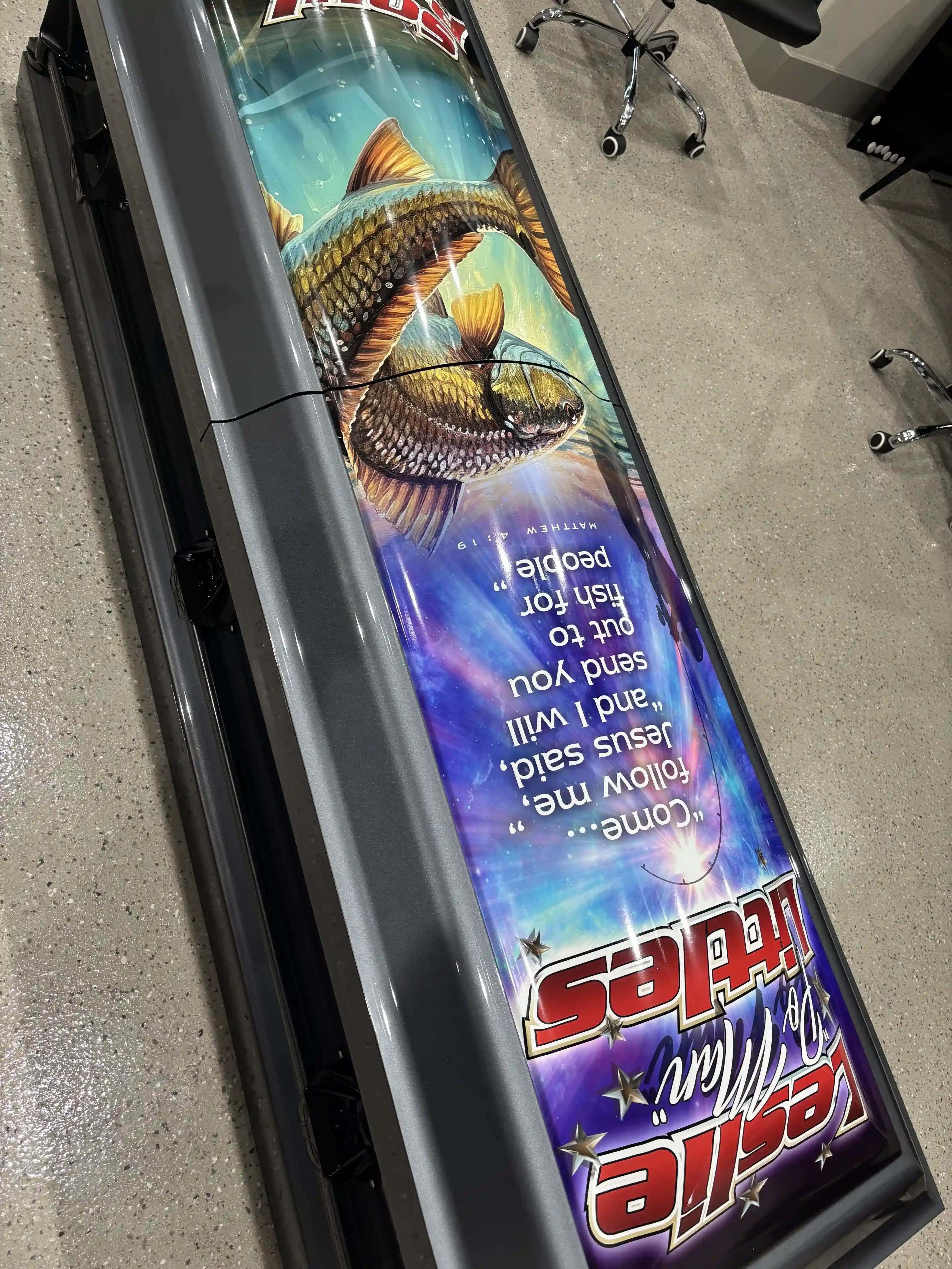 Close view of the redfish mural and Come follow me scripture on the Soul Patrol fishing casket